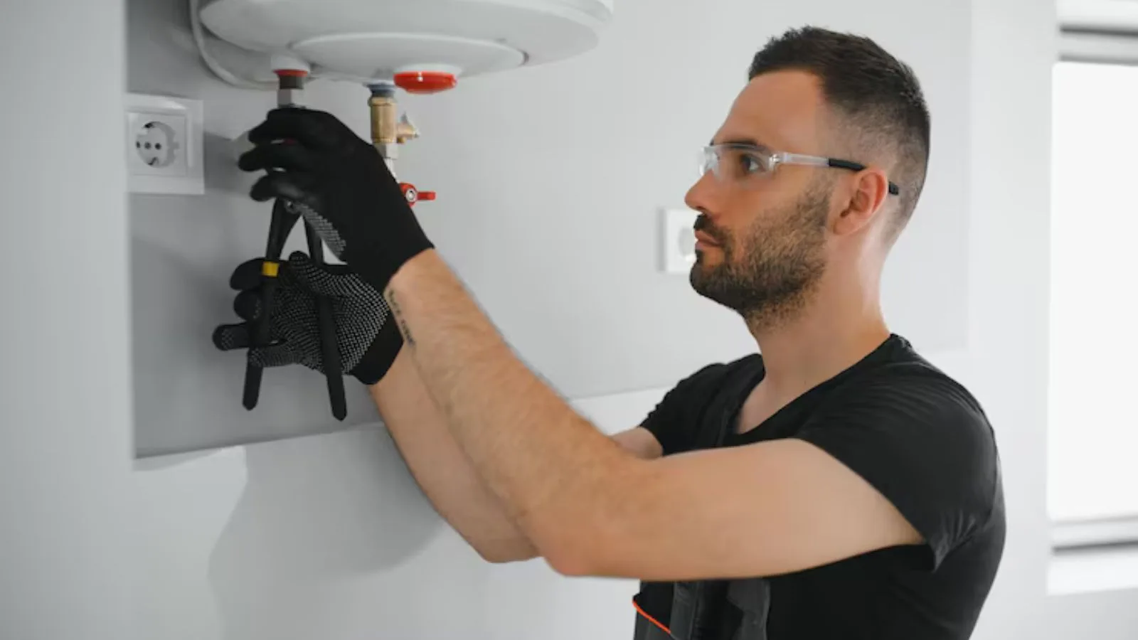 Plumber repairing a water heater in Kennesaw, GA